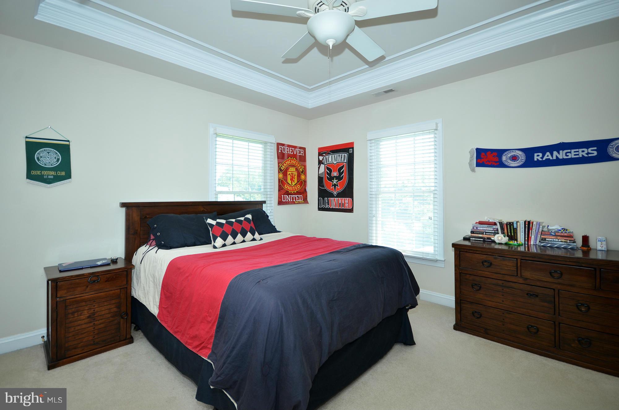 3401 Meredith Ridge Road Phoenix, MD 21131 - Photo 17 of 28 a bedroom with a bed and a chandelier