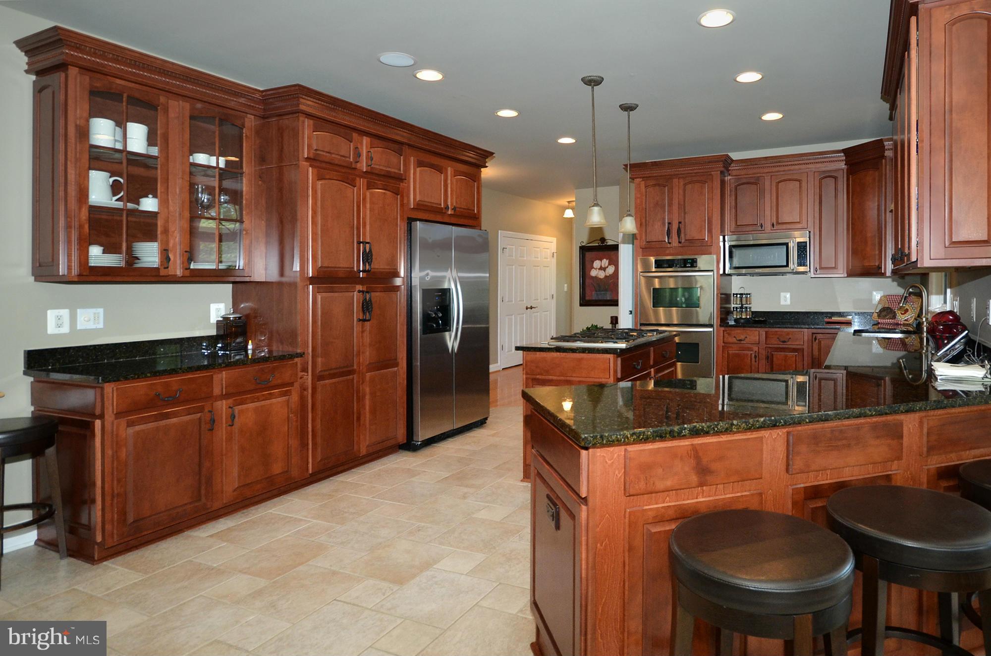 3401 Meredith Ridge Road Phoenix, MD 21131 - Photo 5 of 28 a kitchen with stainless steel appliances granite countertop a sink refrigerator and cabinets