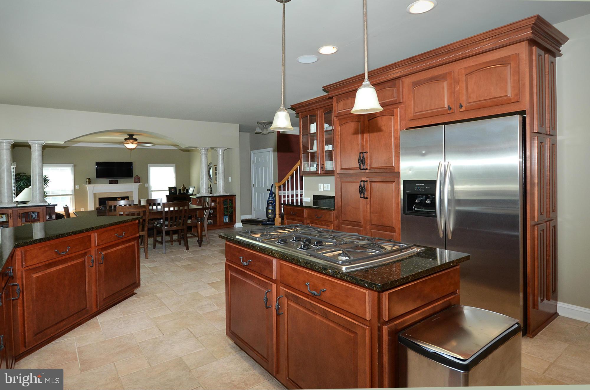 3401 Meredith Ridge Road Phoenix, MD 21131 - Photo 7 of 28 a kitchen with stainless steel appliances granite countertop a stove refrigerator and cabinets