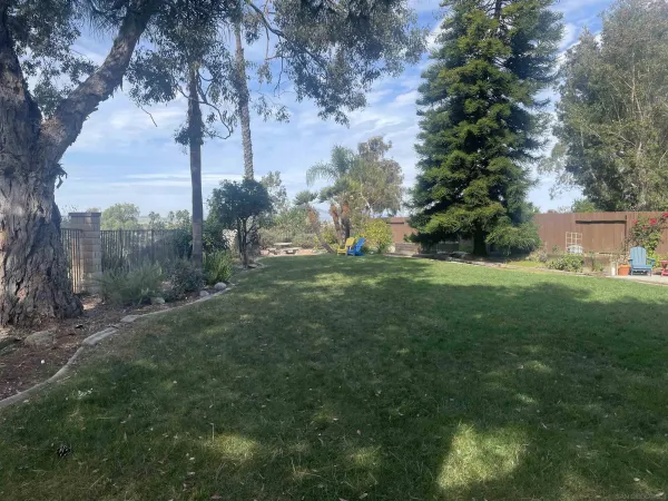 a view of a house with backyard sitting area and garden