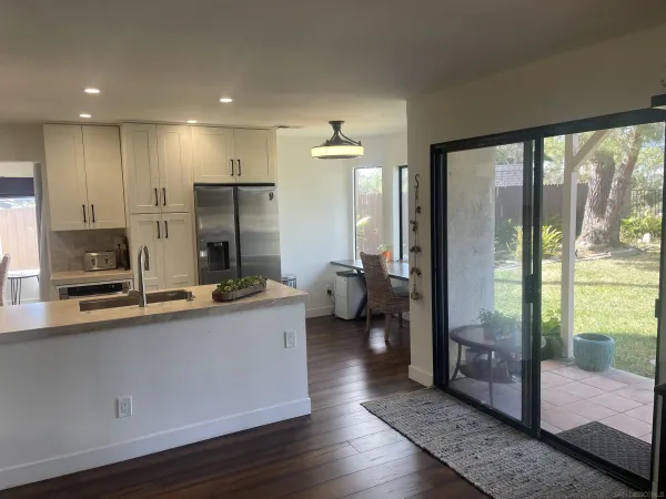 a kitchen with stainless steel appliances a sink and refrigerator