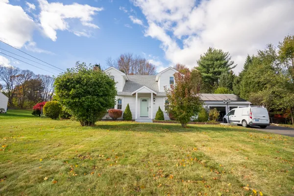 a view of a house with a yard and garage