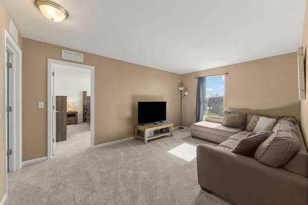 a bedroom with a bed and a ceiling fan in it
