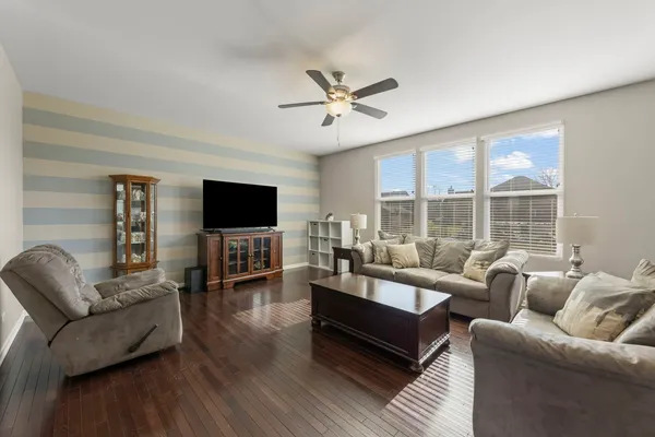 a living room with furniture a flat screen tv and a fireplace
