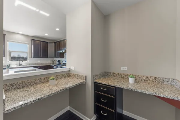 a view of a kitchen counter top space sink and cabinets