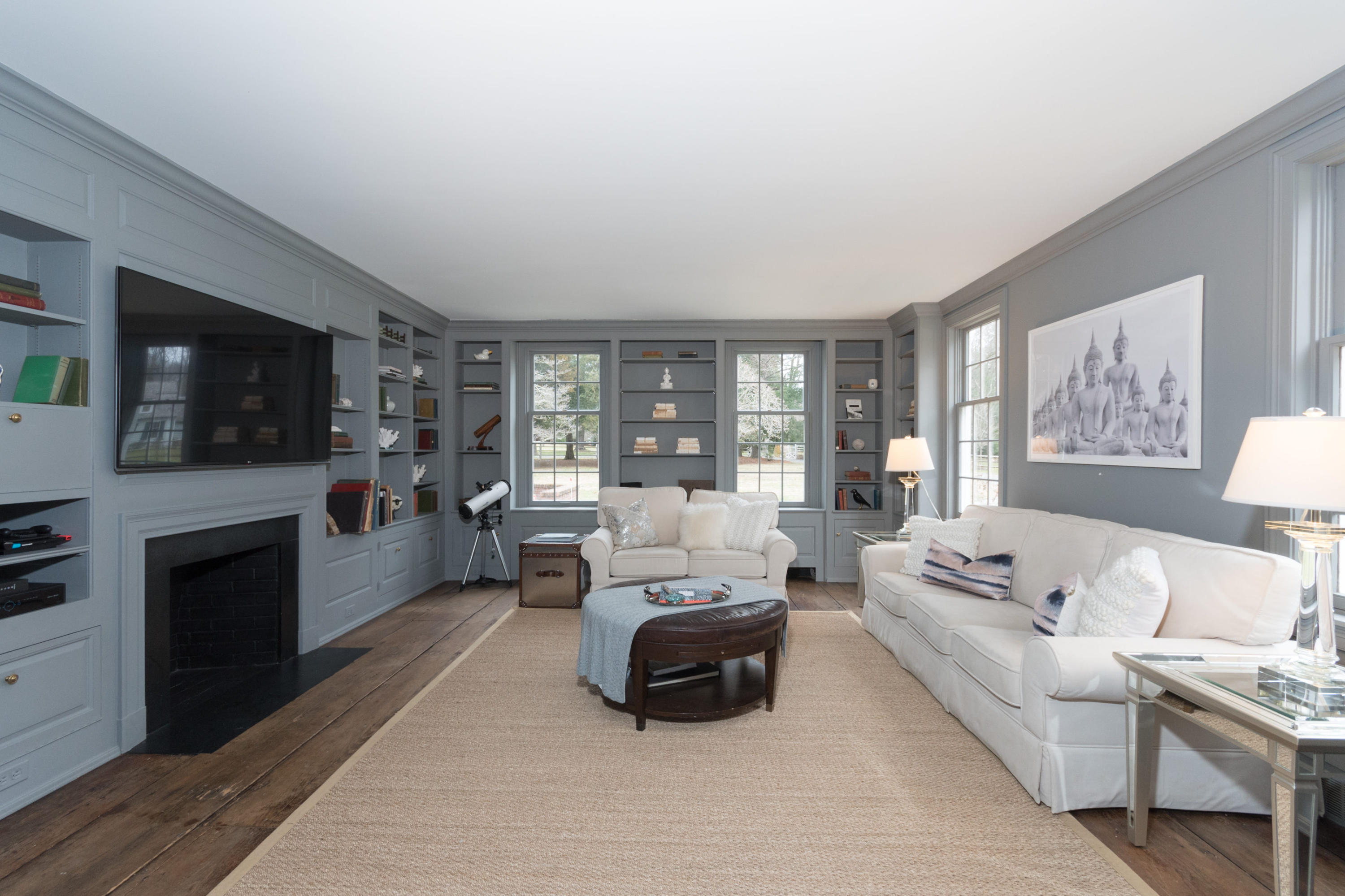 95 Half Mile Road Darien, CT 06820 - Photo 20 of 36 a living room with furniture flat screen tv and a fireplace