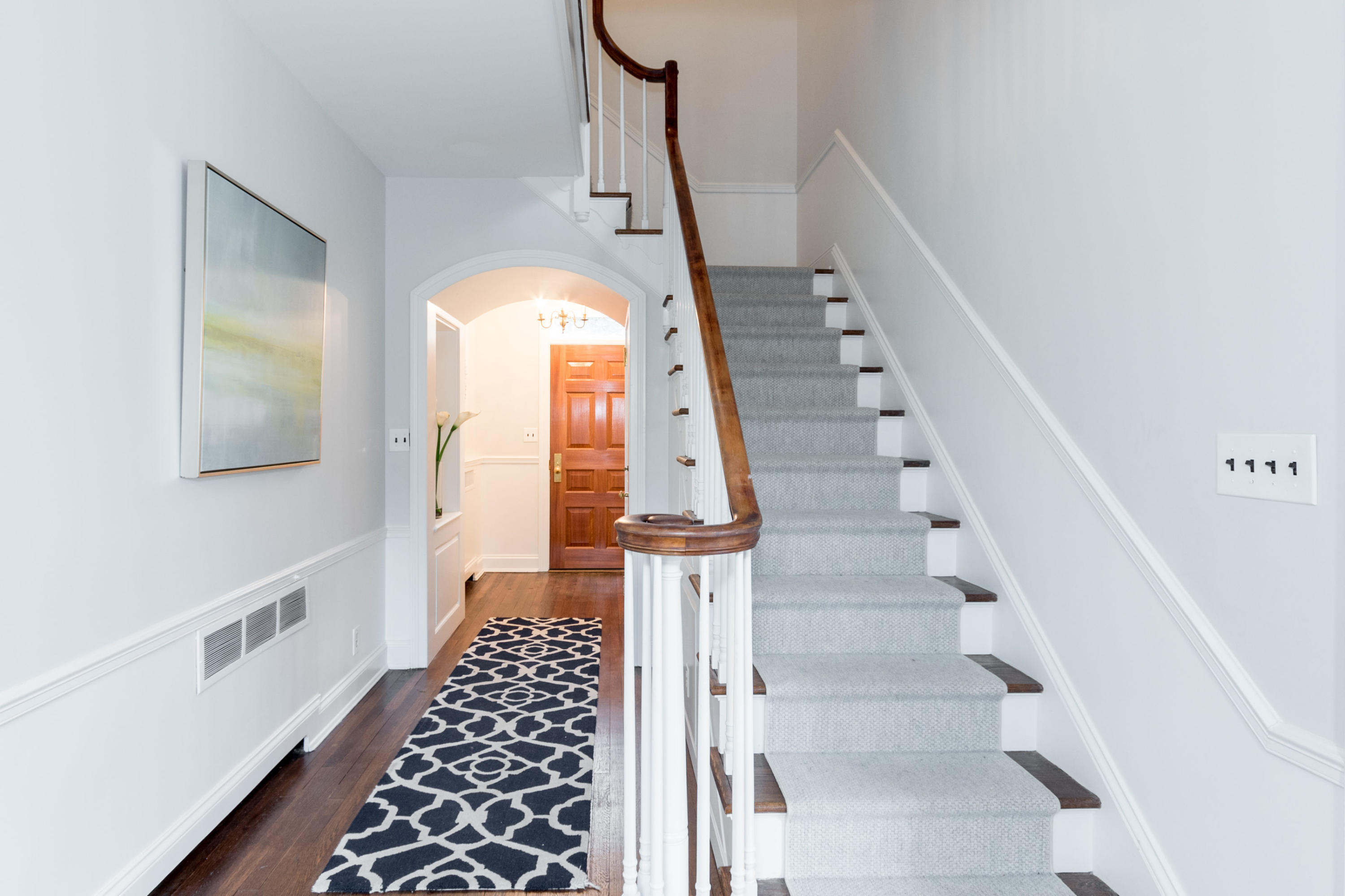 95 Half Mile Road Darien, CT 06820 - Photo 6 of 36 a view of staircase with wooden floor and white walls