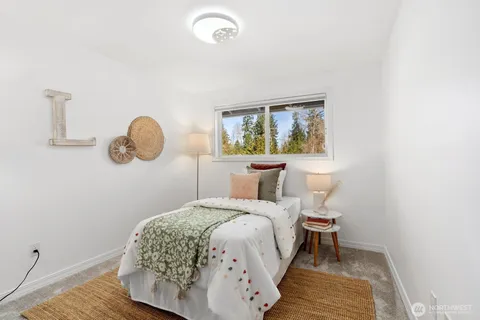 a view of a chair and table in backyard of the house