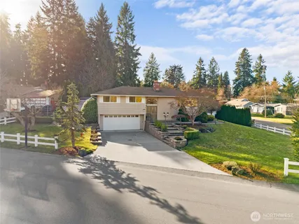 a dining room with furniture and a potted plant