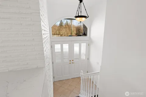 a bedroom with a bed and painting on the wall