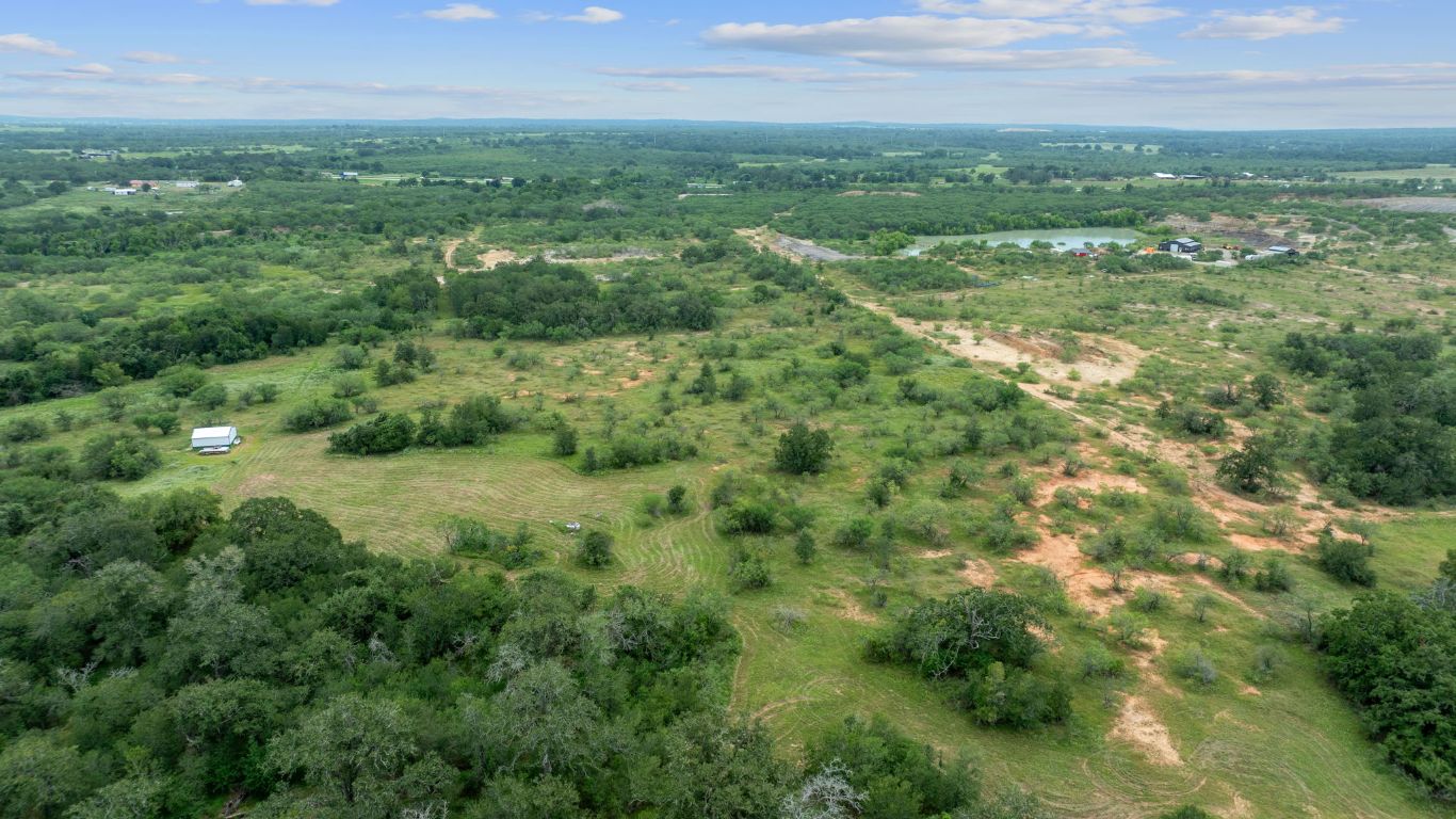 3597 Baker Road Kingsbury, TX 78638 - Photo 2 of 39 a view of a city with lush green forest