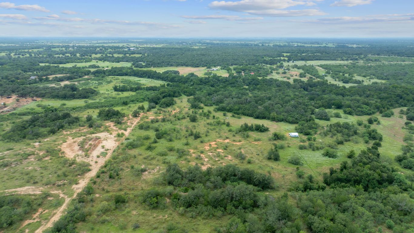 3597 Baker Road Kingsbury, TX 78638 - Photo 4 of 39 an aerial view of residential houses with outdoor space and trees