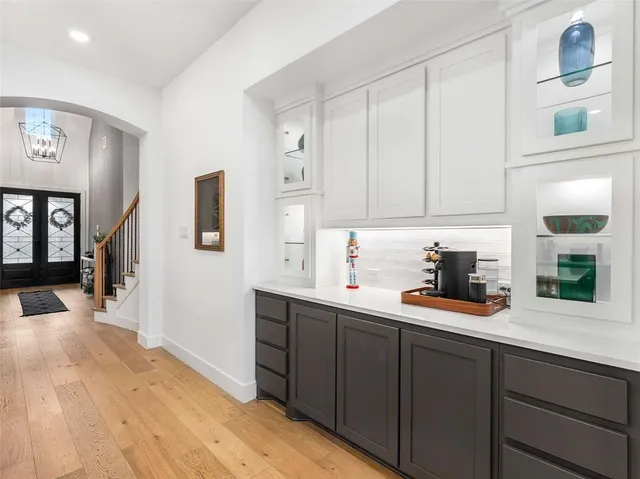 a kitchen with stainless steel appliances a table chairs refrigerator and microwave