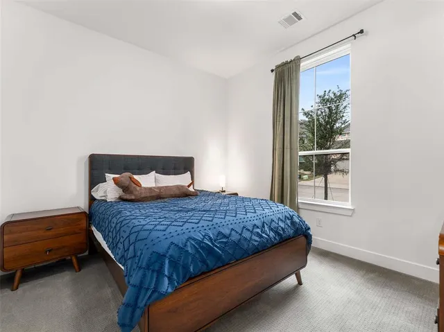 a bathroom with a white tub a mirror and vanity