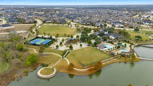 an aerial view of a residential houses with outdoor space and river view