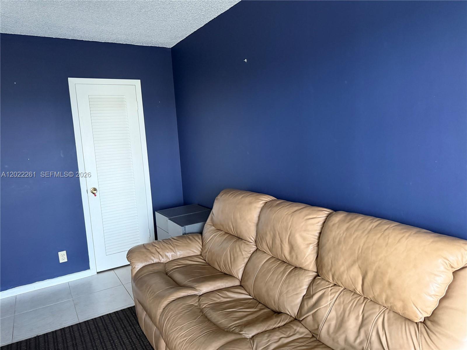 4043 Cornwall C, Unit 4043 Boca Raton, FL 33434 - Photo 10 of 16 a bed sitting in a bedroom next to a window
