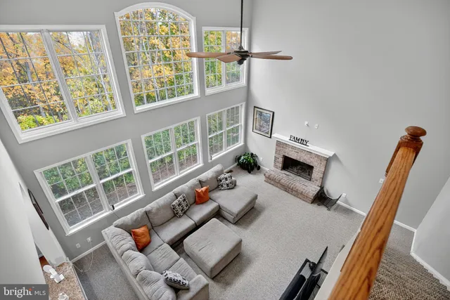 a living room with furniture a flat screen tv and a window