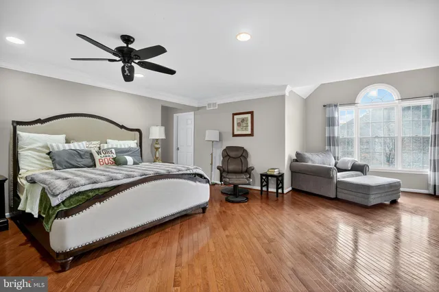 a bedroom with a bed couch and window