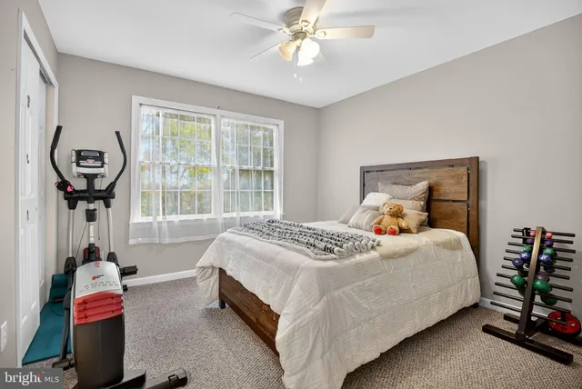 a bedroom with bed and a window