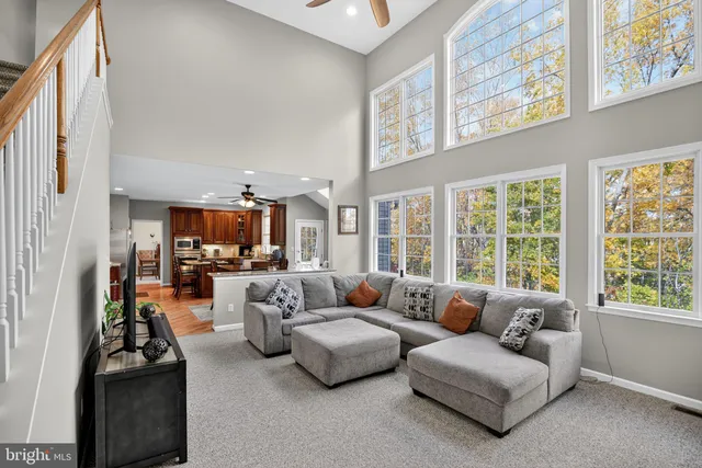 a living room with furniture fireplace and a large window