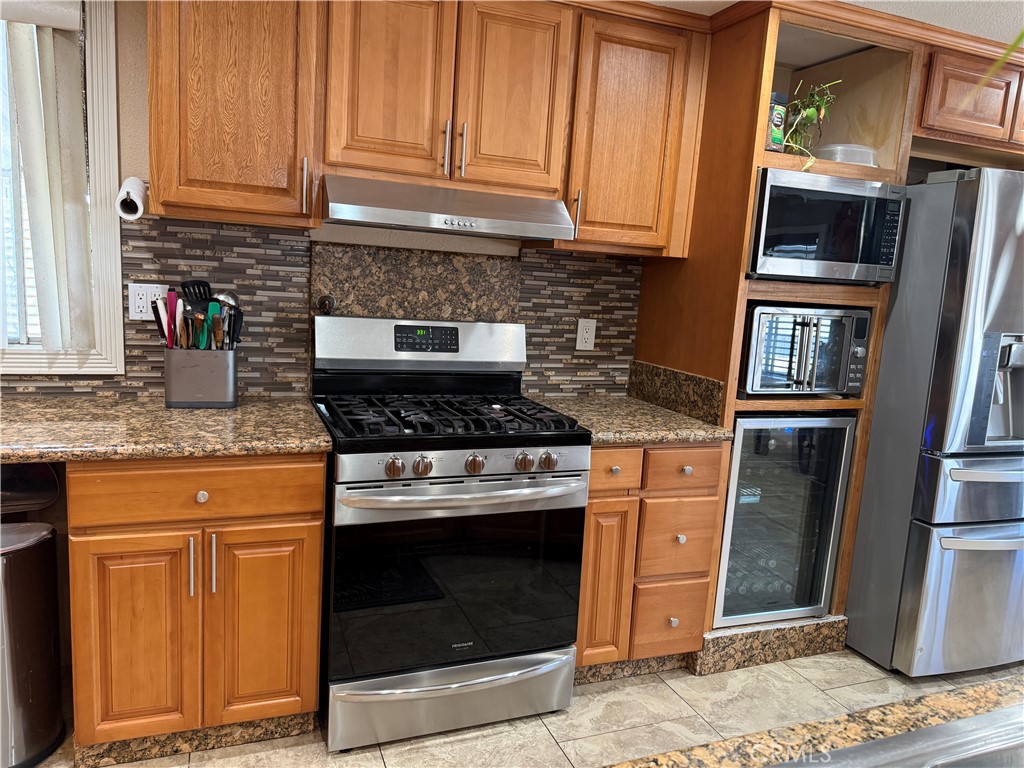 20683 Waalew Road, Unit B37 Apple Valley, CA 92307 - Photo 16 of 24 a kitchen with granite countertop cabinets stainless steel appliances and a sink