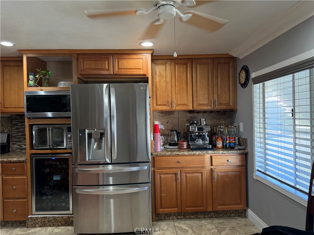 20683 Waalew Road, Unit B37 Apple Valley, CA 92307 - Photo 17 of 24 a kitchen with a refrigerator and cabinets