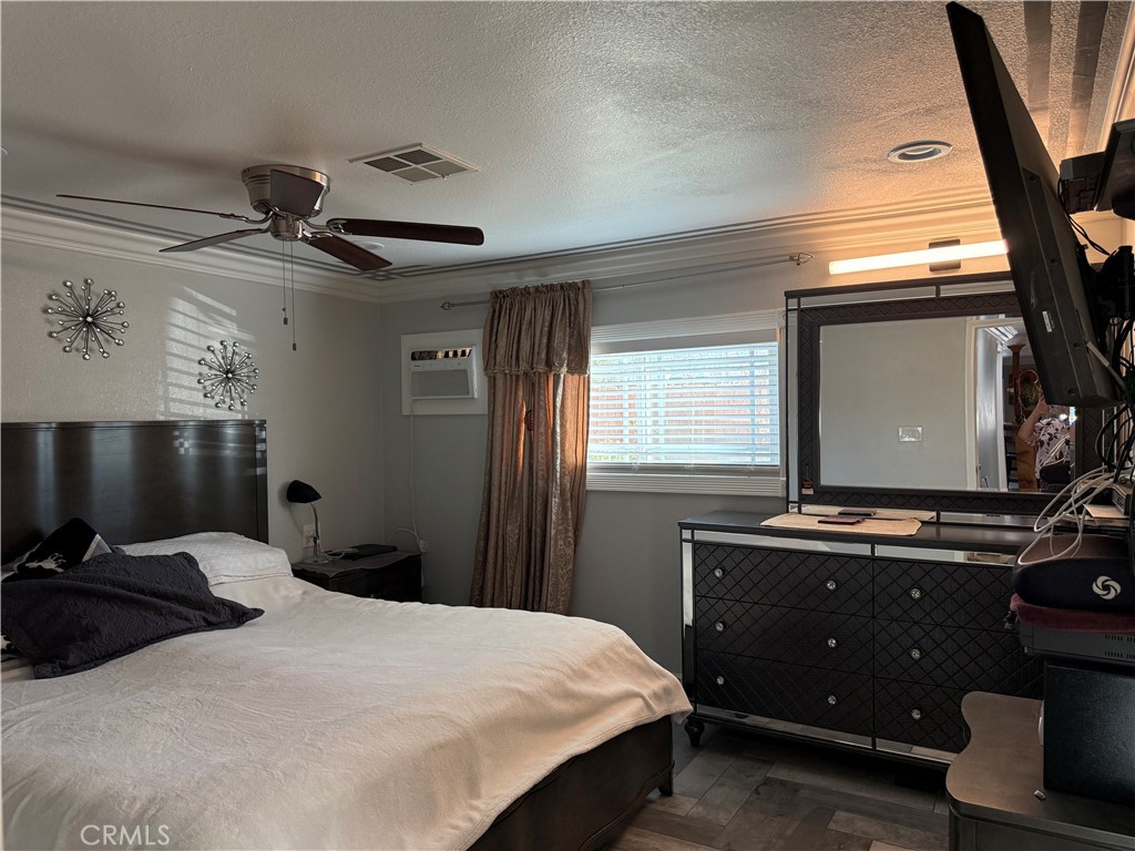 20683 Waalew Road, Unit B37 Apple Valley, CA 92307 - Photo 3 of 24 a bedroom with a bed and a flat tv screen on the dresser