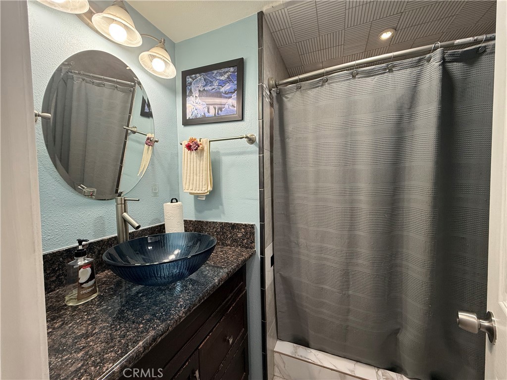 20683 Waalew Road, Unit B37 Apple Valley, CA 92307 - Photo 4 of 24 a bathroom with a granite countertop sink and a mirror