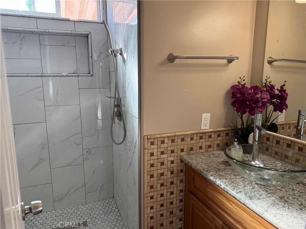 20683 Waalew Road, Unit B37 Apple Valley, CA 92307 - Photo 9 of 24 a bathroom with a granite countertop shower a sink and a mirror