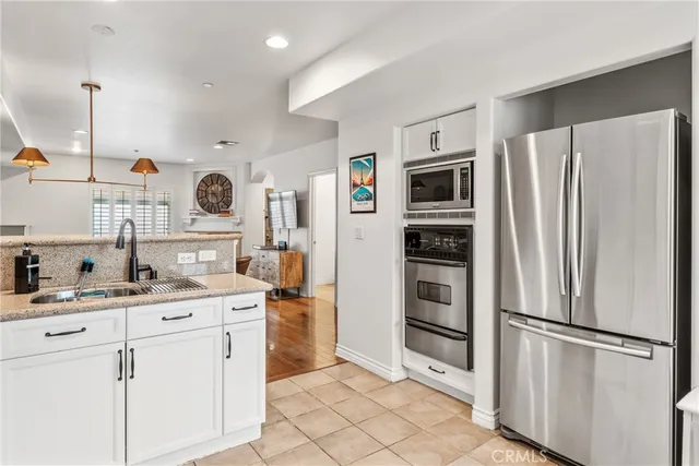 a bathroom with a granite countertop toilet sink and mirror