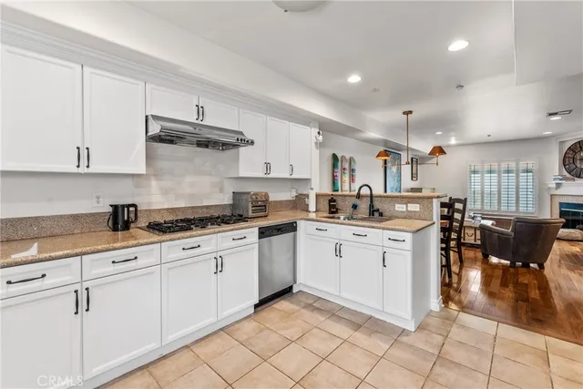 a bathroom with a granite countertop sink a mirror and shower
