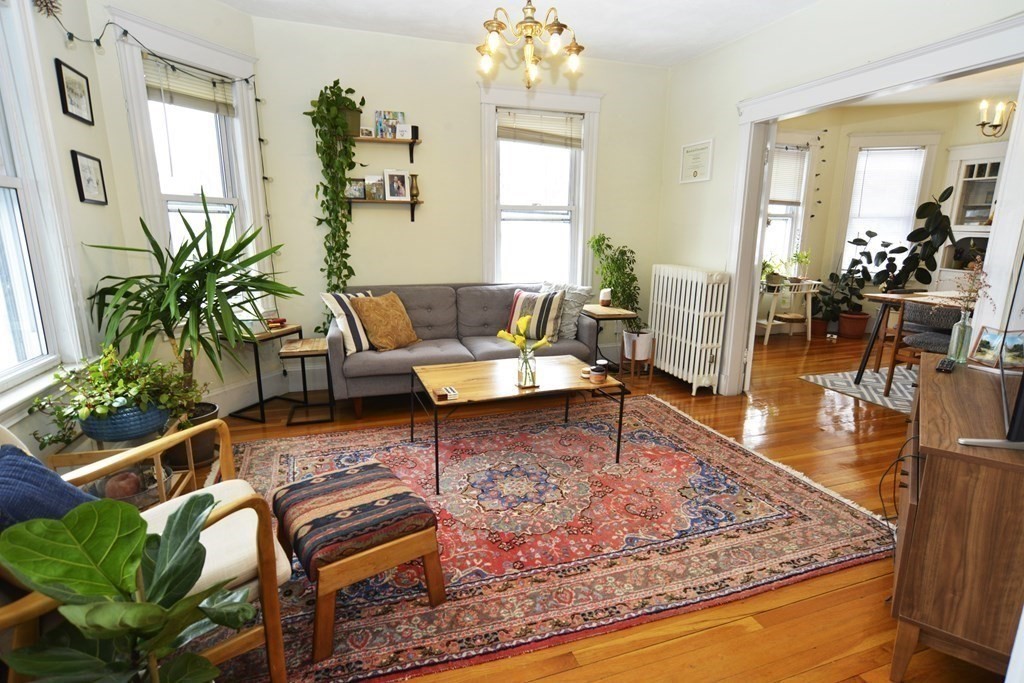 89 Rockview Street, Unit 3 Boston, MA 02130 - Photo 1 of 1 a living room with furniture and a chandelier