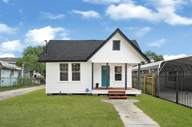a view of a house with backyard and porch
