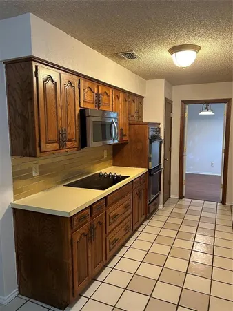 a kitchen with stainless steel appliances a sink and a refrigerator