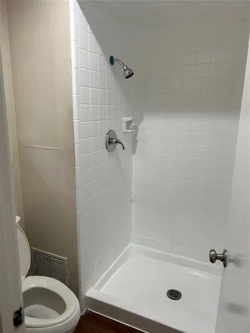 a bathroom with a tub and a toilet