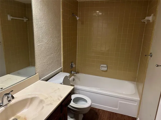 a bathroom with a sink a toilet and a bathtub