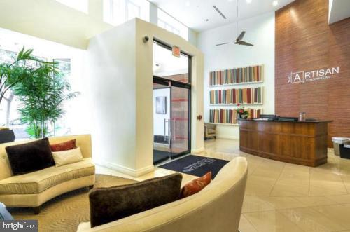915 E Street Northwest, Unit 714 Washington, DC 20004 - Photo 1 of 14 a living room with furniture and a potted plant