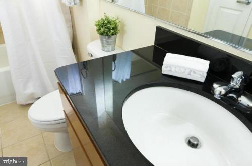 915 E Street Northwest, Unit 714 Washington, DC 20004 - Photo 12 of 14 a picture of a bathroom with a sink and a mirror