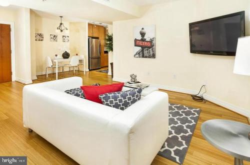 915 E Street Northwest, Unit 714 Washington, DC 20004 - Photo 3 of 14 a living room with a couch and a flat screen tv