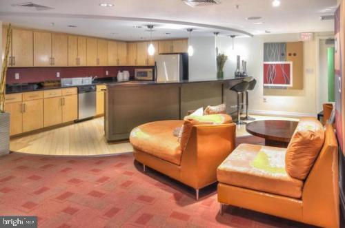 915 E Street Northwest, Unit 714 Washington, DC 20004 - Photo 4 of 14 a living room with furniture and kitchen view