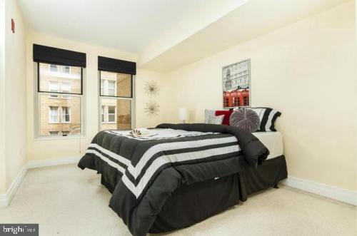 915 E Street Northwest, Unit 714 Washington, DC 20004 - Photo 10 of 14 a bedroom with a bed and a window