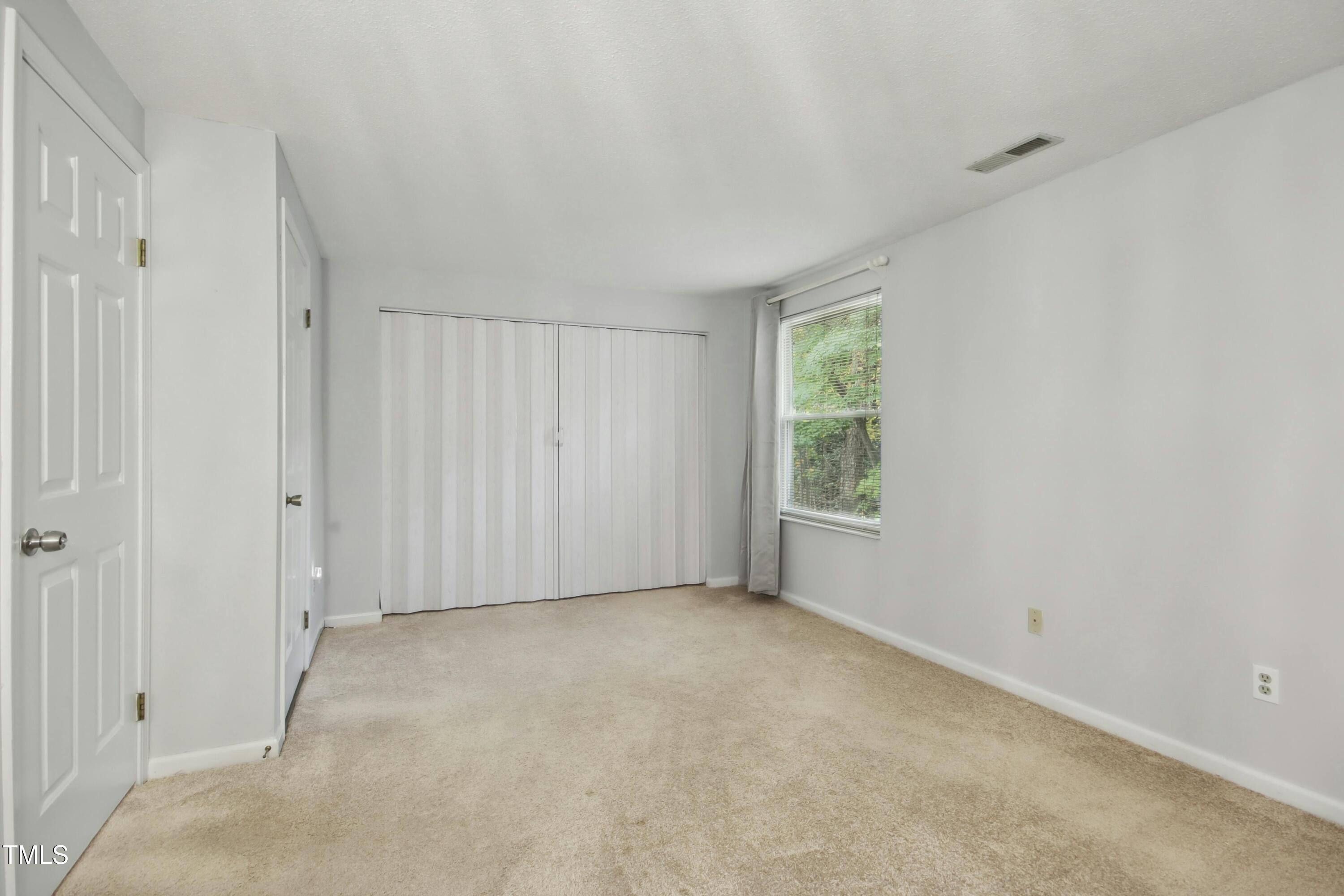 7803 Stephanie Lane Raleigh, NC 27615 - Photo 13 of 30 a view of an empty room with a window