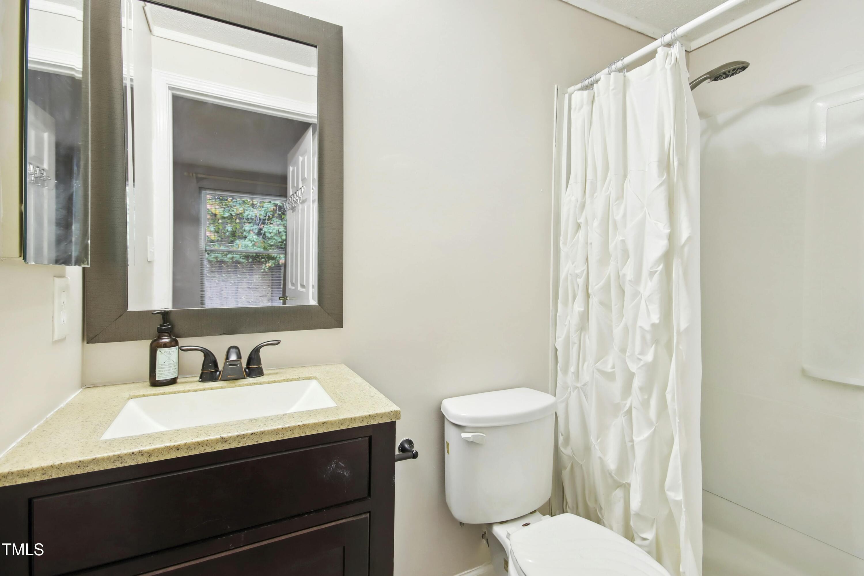 7803 Stephanie Lane Raleigh, NC 27615 - Photo 16 of 30 a bathroom with a sink toilet and shower