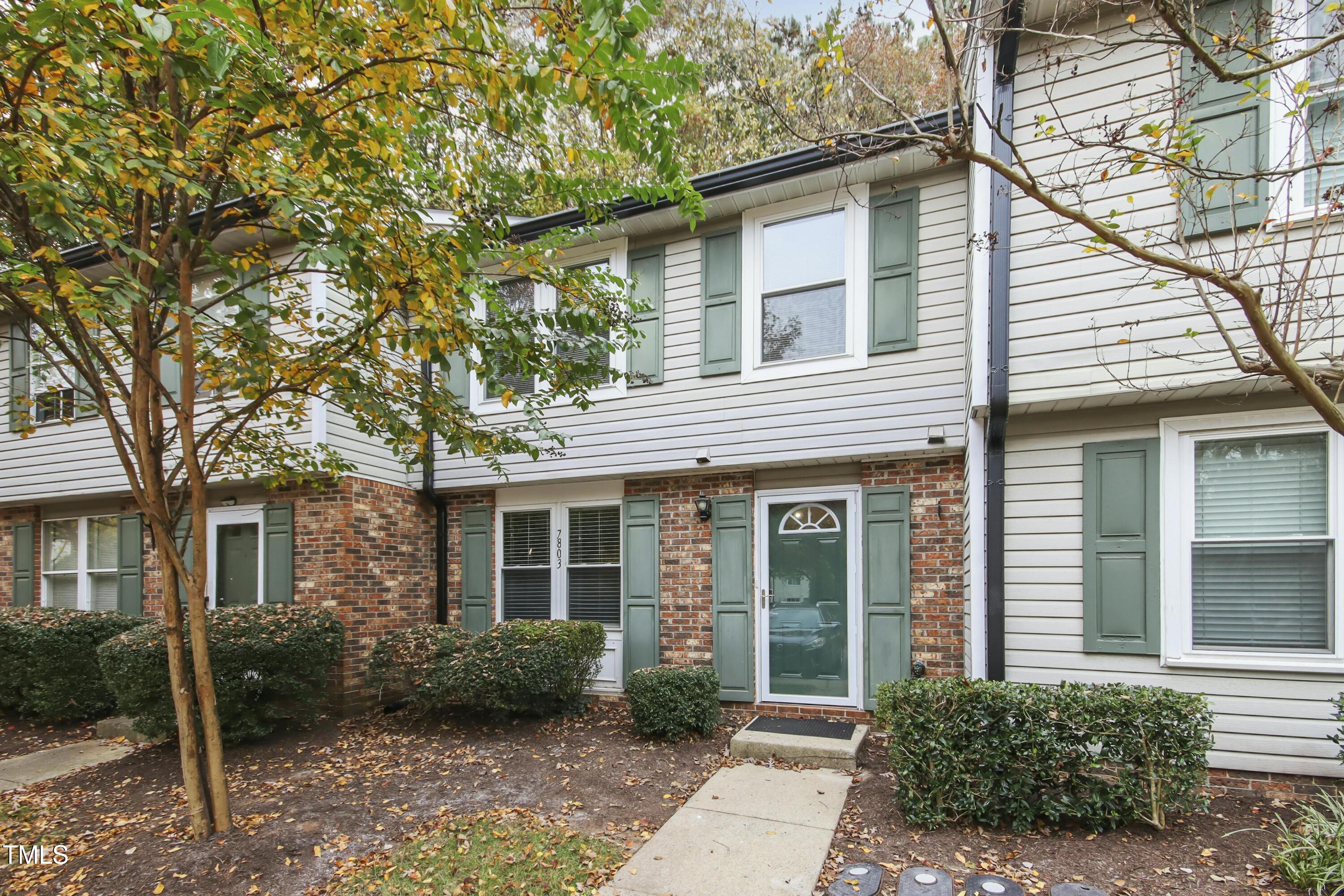 7803 Stephanie Lane Raleigh, NC 27615 - Photo 2 of 30 a view of a white house next to a yard