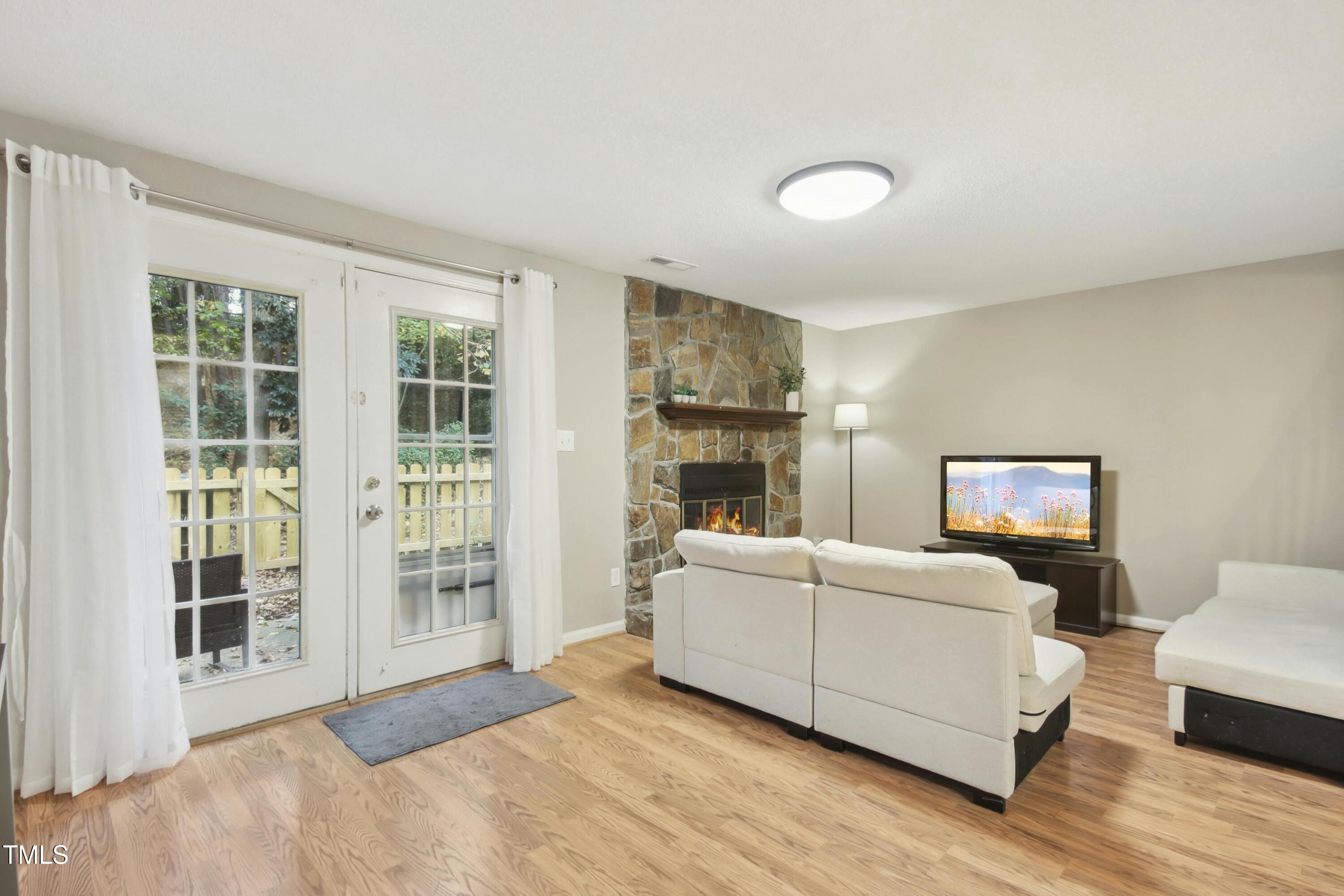 7803 Stephanie Lane Raleigh, NC 27615 - Photo 4 of 30 a living room with furniture and a potted plant next to a window