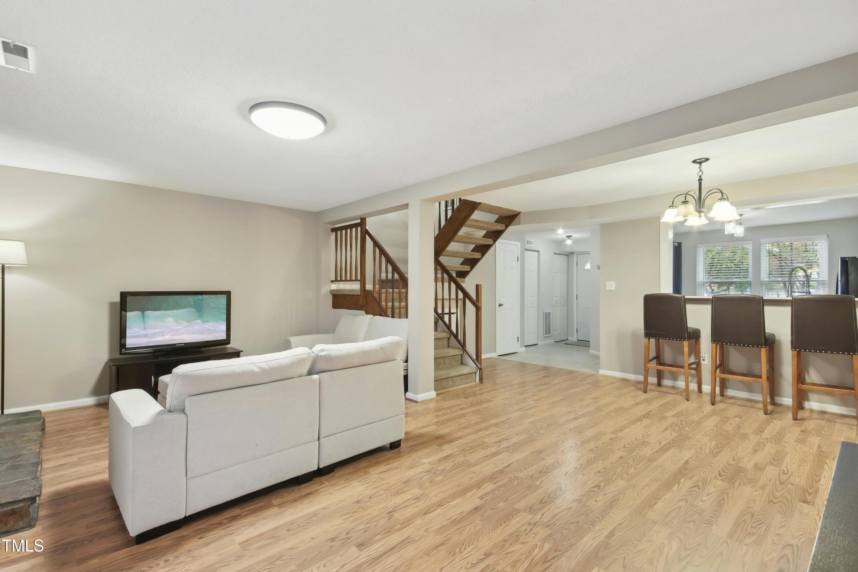 7803 Stephanie Lane Raleigh, NC 27615 - Photo 5 of 30 a living room with furniture and a wooden floor