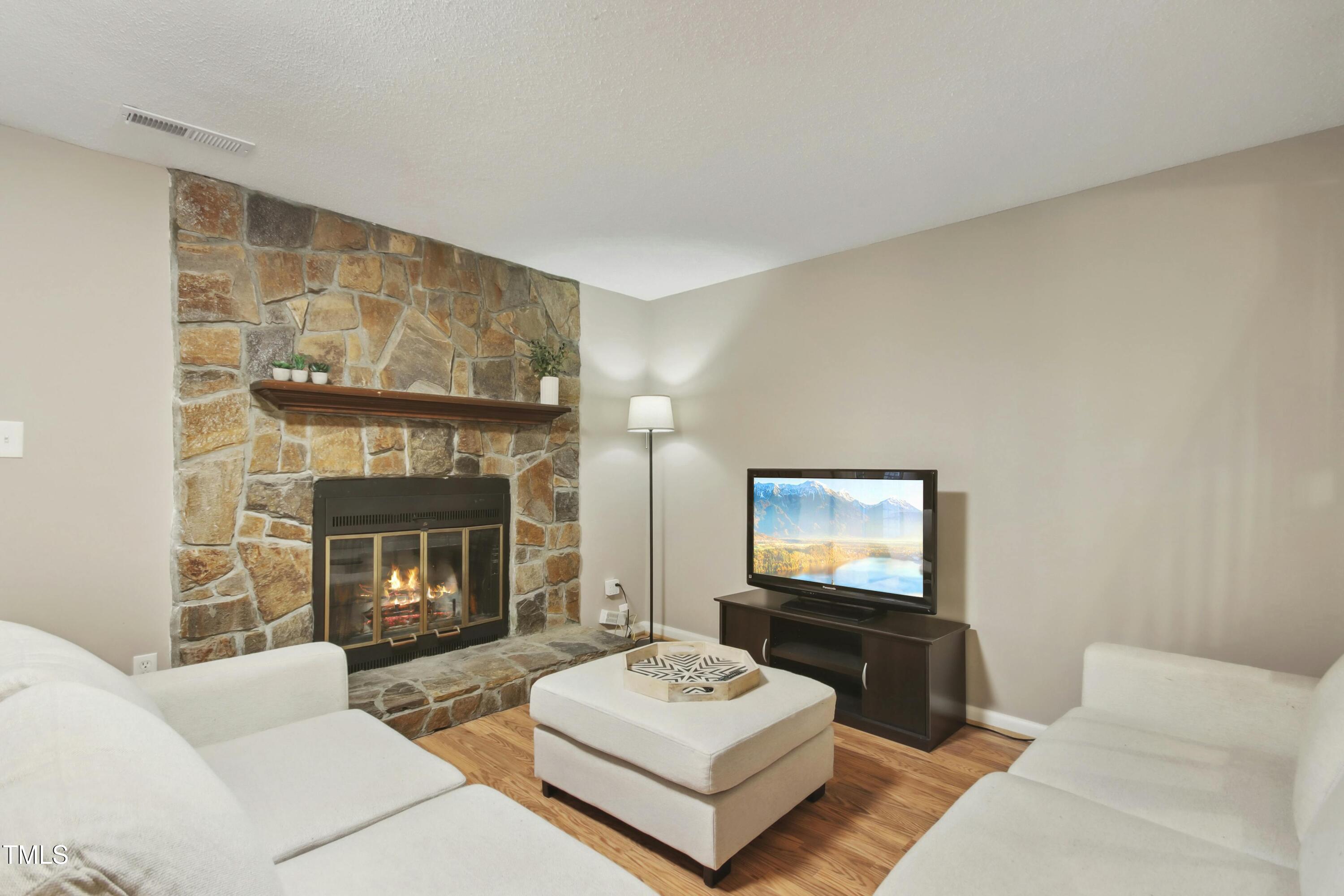 7803 Stephanie Lane Raleigh, NC 27615 - Photo 6 of 30 a living room with furniture and a fireplace