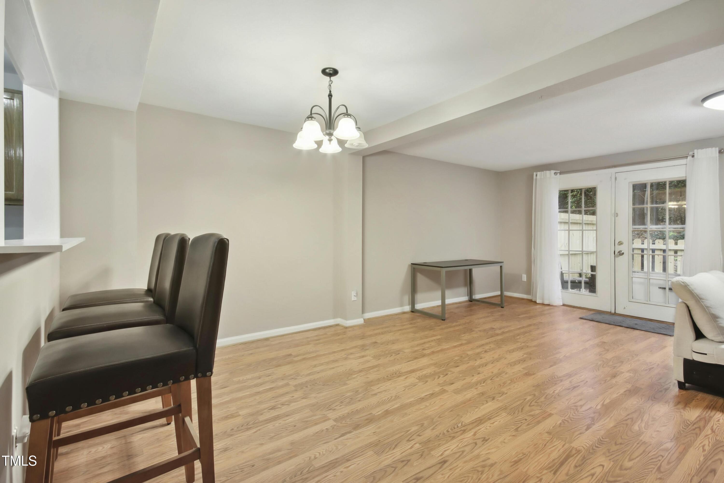 7803 Stephanie Lane Raleigh, NC 27615 - Photo 8 of 30 a view of a livingroom with a furniture and wooden floor