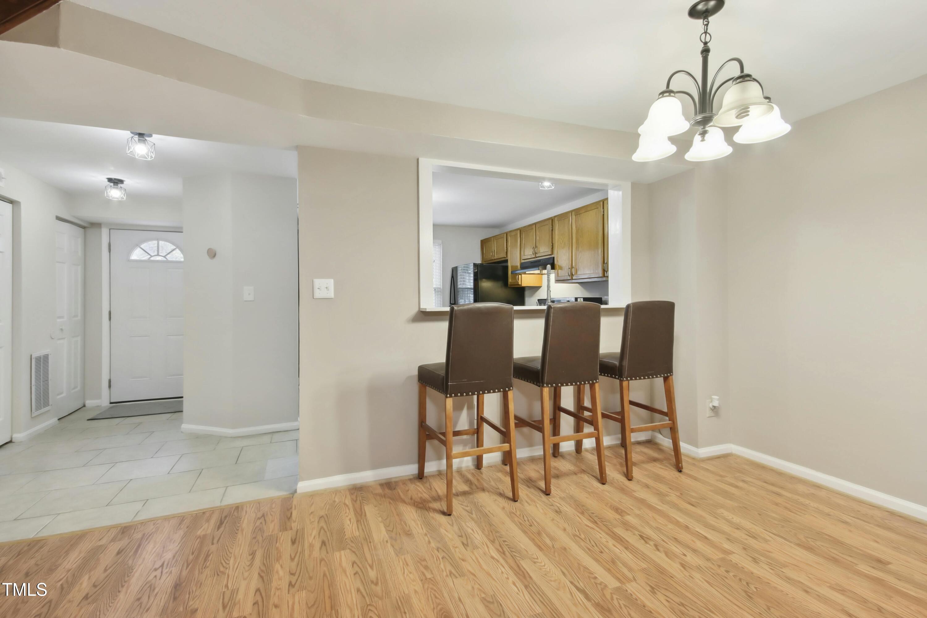 7803 Stephanie Lane Raleigh, NC 27615 - Photo 9 of 30 a view of a dining room with furniture and wooden floor