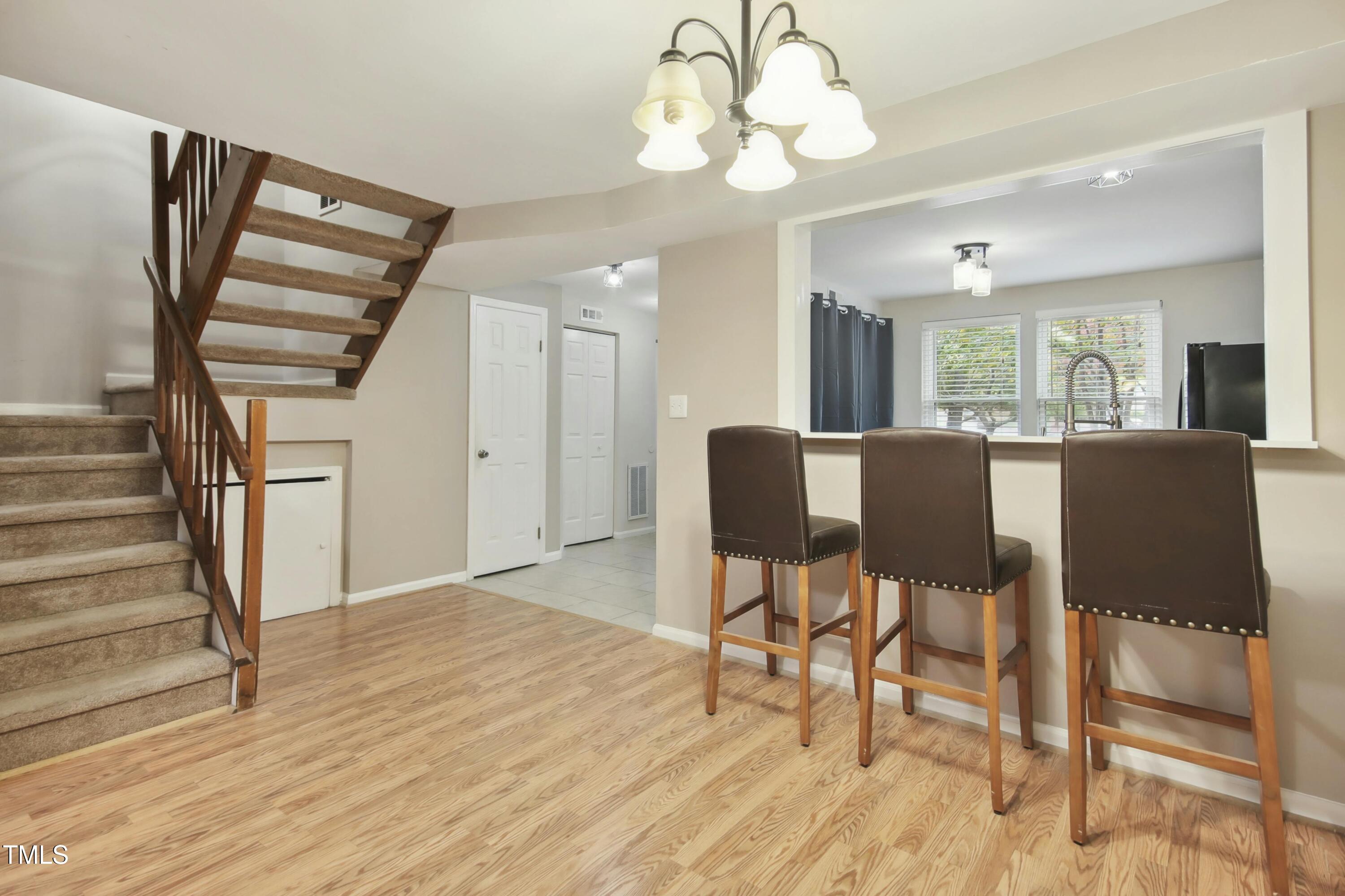 7803 Stephanie Lane Raleigh, NC 27615 - Photo 10 of 30 a view of a dining room with furniture window and wooden floor